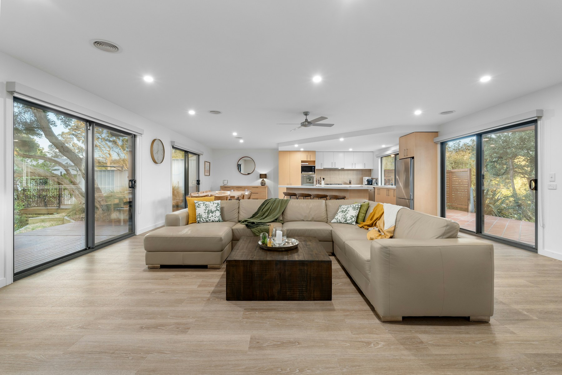 Illustrative modern living room with wide glass doors opening to a garden